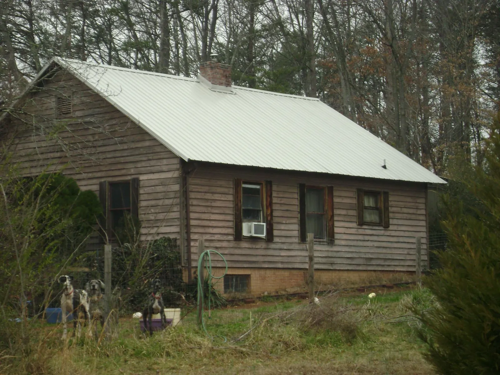 White metal roof on an old wood sided farmhouse, from a Metal Roof Installation job in Coolin